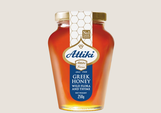 Glas Honig Attiki mit goldenem Deckel und Etikett in Blau und Weiß, 250g.